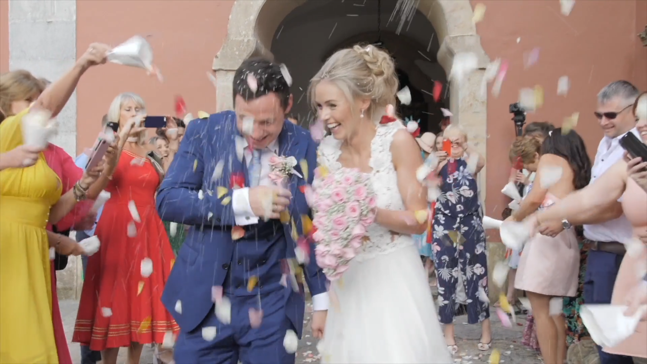 bride and groom getting showered with confetti outside of a church