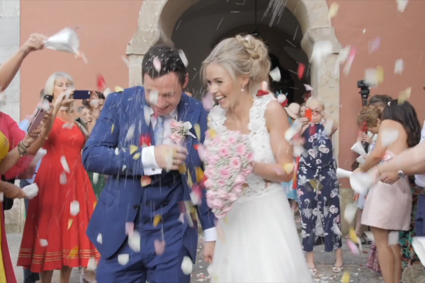 bride and groom getting showered with confetti outside of a church