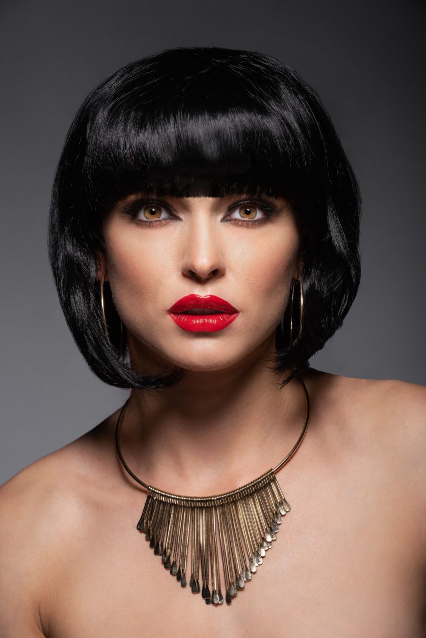 Portrait of a model with red lipstick and black hair and necklace - Silver Award in Commercial Photography by Michael Hayes
