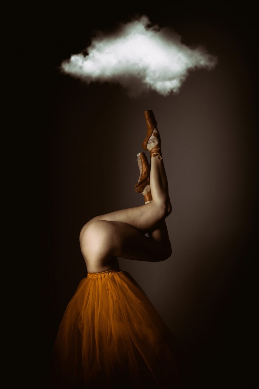 Ballet dancer upside down with legs up and cloud above  - Silver Award in Fine Art Photography by Michael Hayes