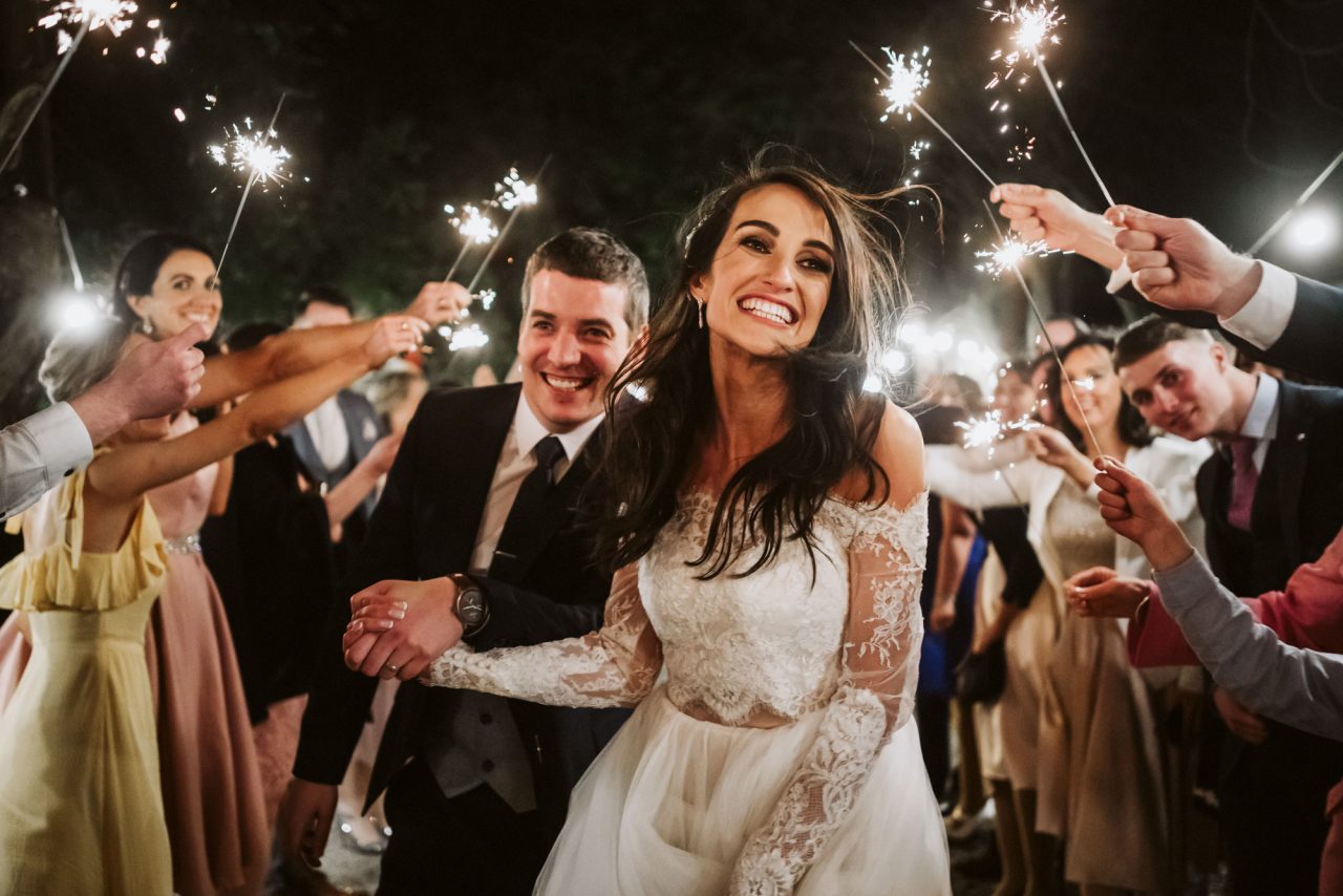 bride and groom with guests and sparklers
