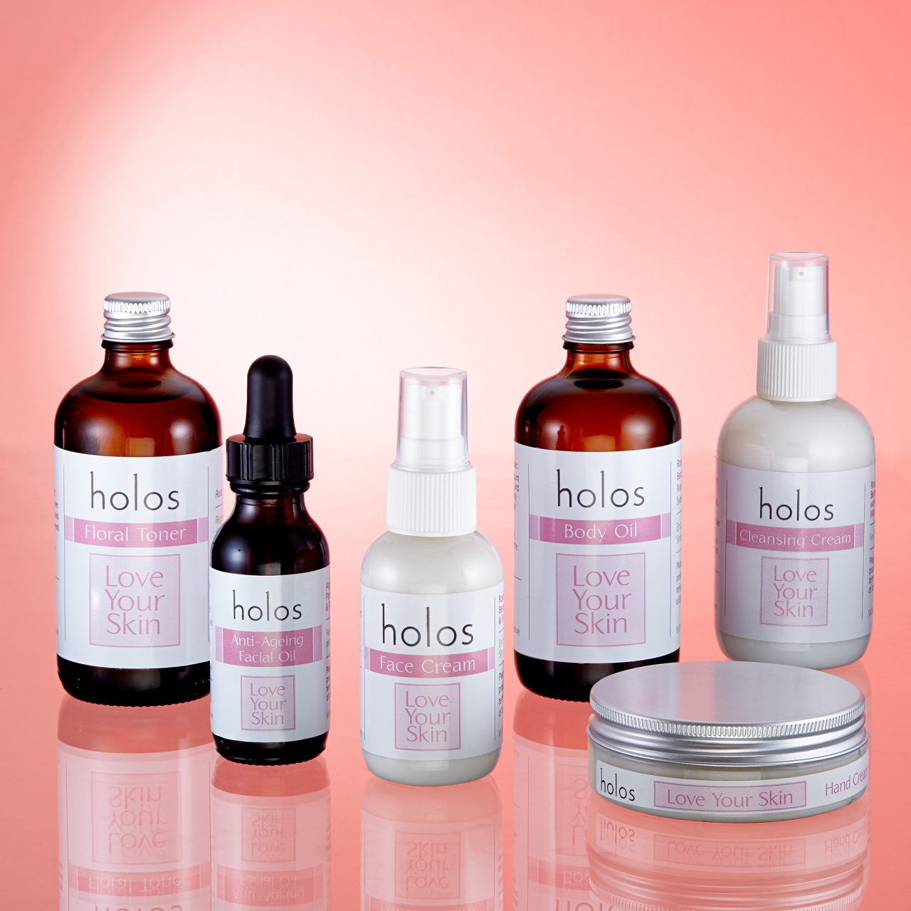 skincare products on a clean pink background