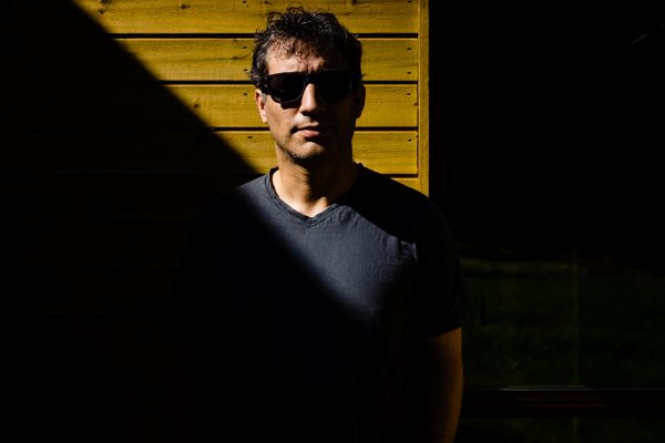 high-contrast profile photo of a photographer with sunglasses