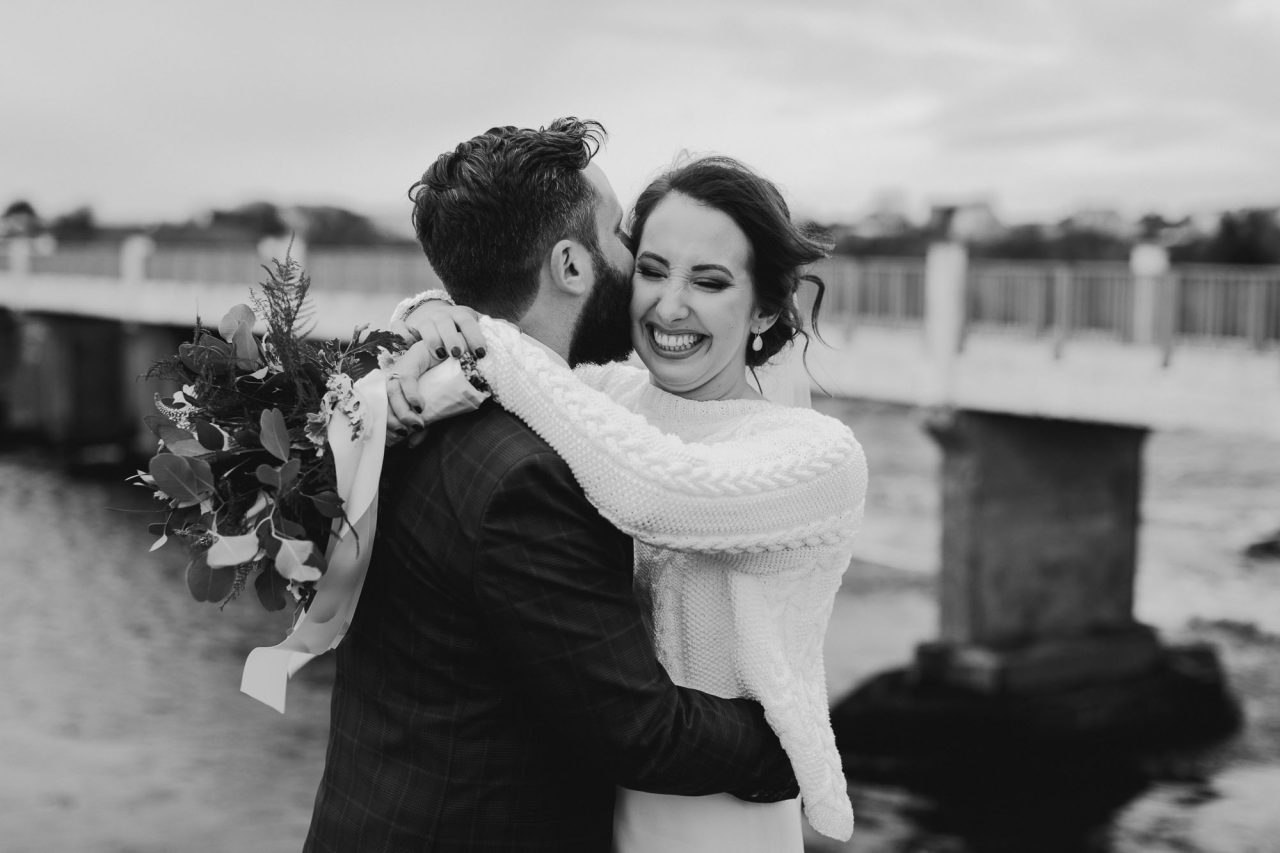 Candid Wedding Photograph of the married couple laughing by IPPVA Member Michelle Prunty