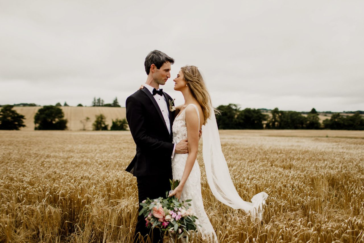 Posed Wedding Photograph of the married couple in a field by IPPVA Member Michelle Prunty